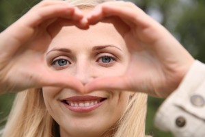 woman depicts the heart as hands